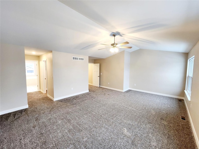 unfurnished room featuring ceiling fan, carpet flooring, and vaulted ceiling