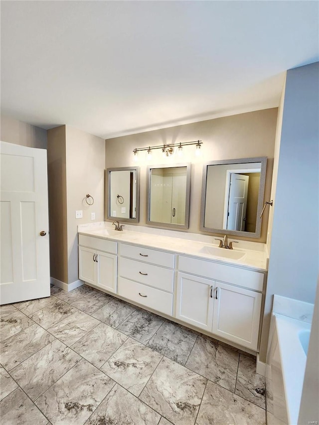 bathroom featuring vanity and a tub