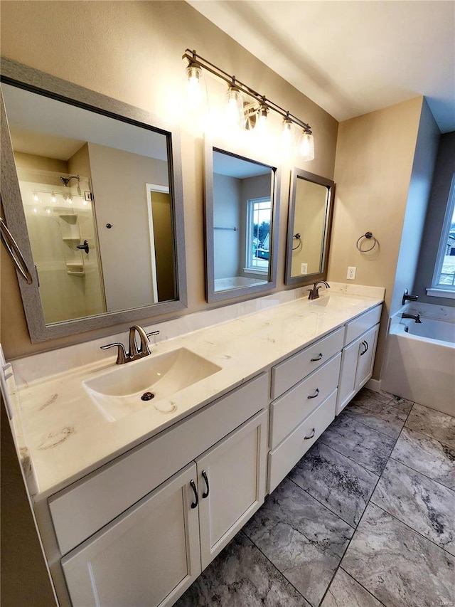 bathroom with vanity and shower with separate bathtub