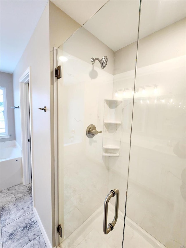 bathroom featuring separate shower and tub