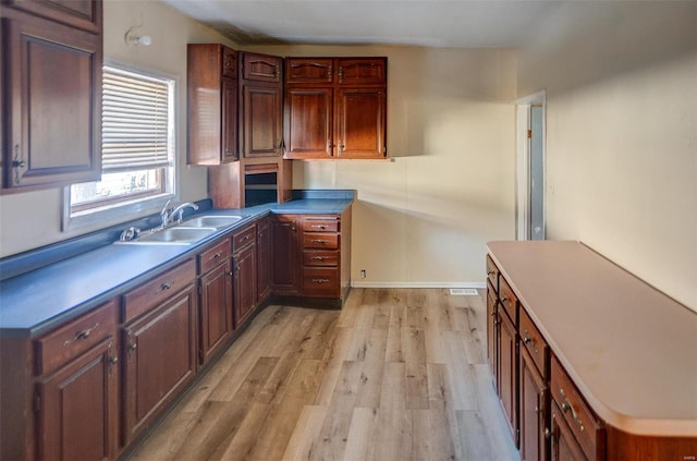 kitchen with sink and light hardwood / wood-style floors