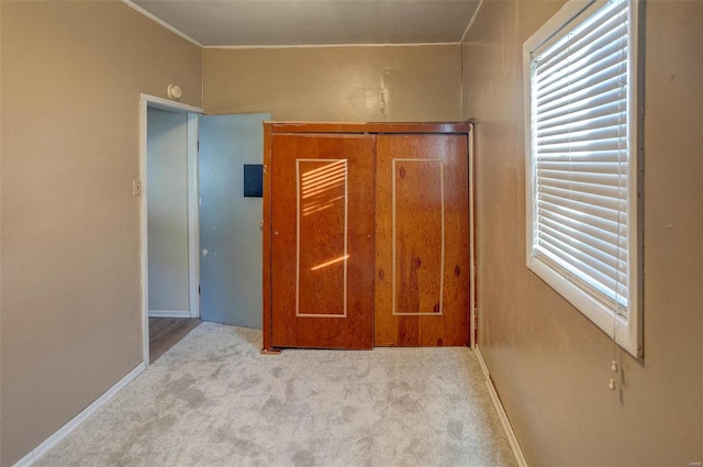 unfurnished bedroom featuring light carpet