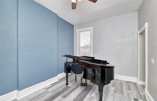 misc room with light hardwood / wood-style flooring and ceiling fan