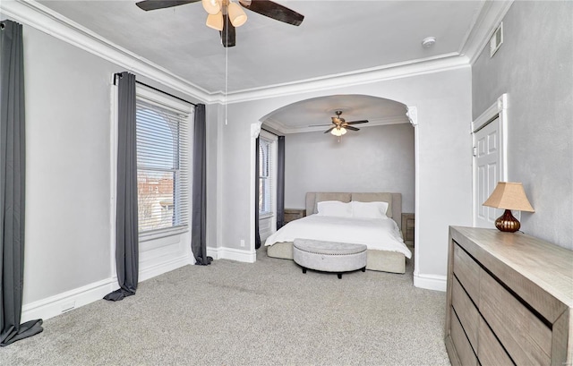 carpeted bedroom with crown molding and ceiling fan