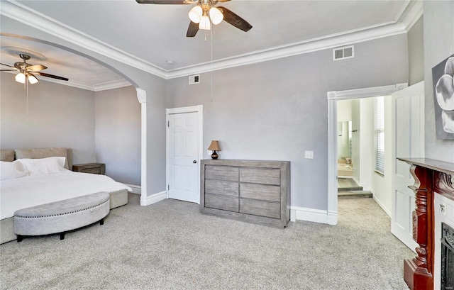 carpeted bedroom with crown molding and ceiling fan