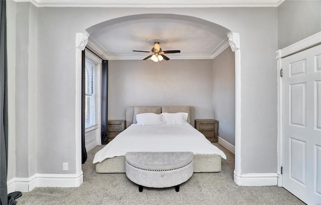 carpeted bedroom with ceiling fan and ornamental molding