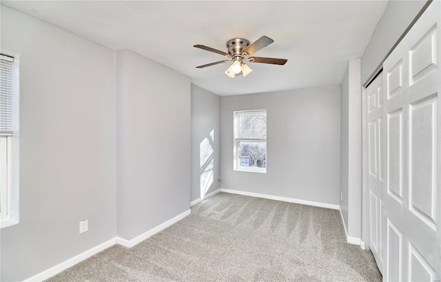 unfurnished room with light colored carpet and ceiling fan