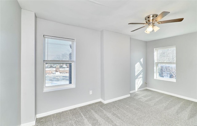 carpeted spare room with ceiling fan