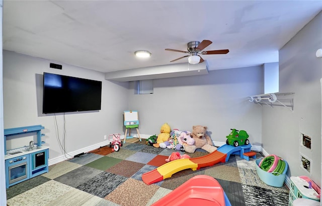 game room featuring dark wood-type flooring and ceiling fan