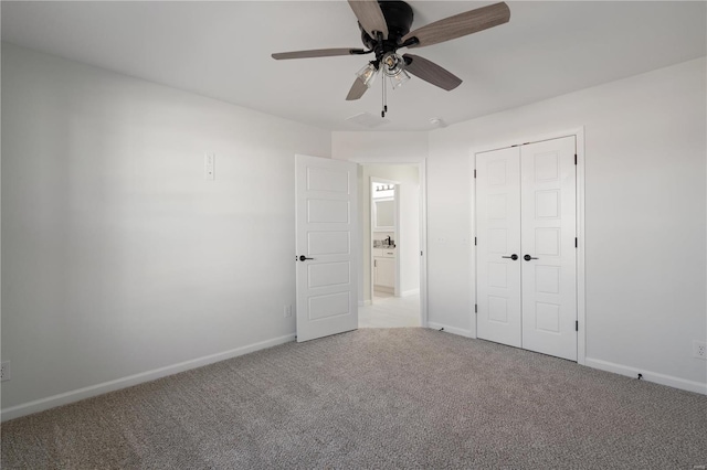 unfurnished bedroom with ceiling fan, light colored carpet, and a closet