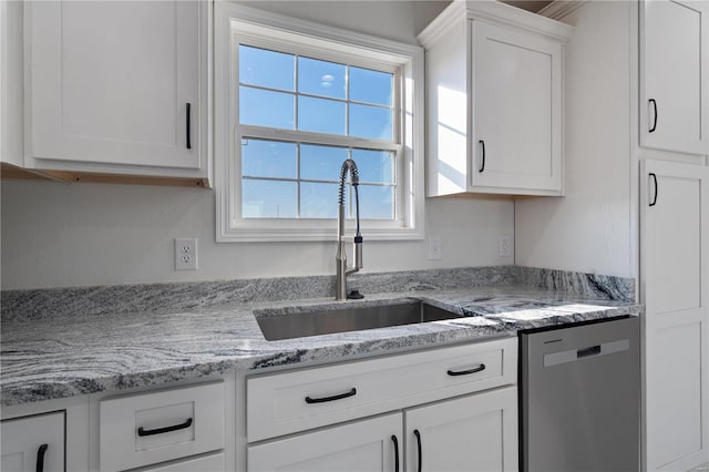 kitchen with white cabinetry, sink, light stone countertops, and dishwasher