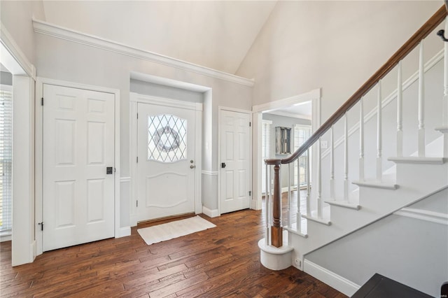 entryway with high vaulted ceiling, dark wood-style flooring, baseboards, and stairs