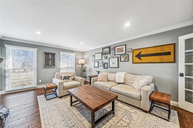 living area with crown molding, baseboards, and hardwood / wood-style flooring