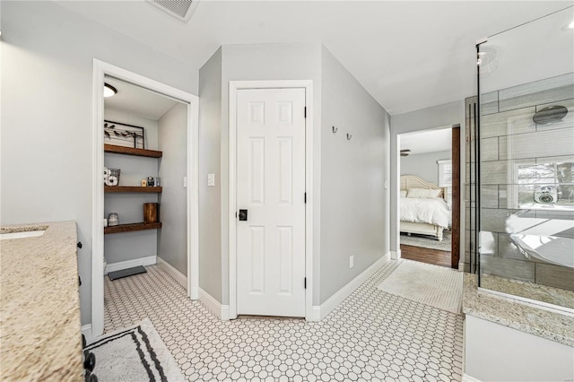 full bath featuring a walk in shower, connected bathroom, visible vents, and baseboards