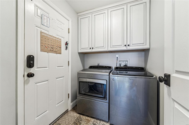 clothes washing area with separate washer and dryer, cabinet space, and tile patterned floors