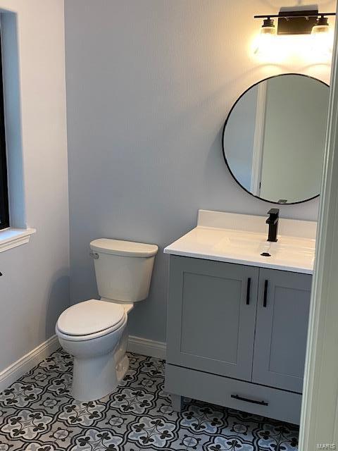 bathroom with vanity, toilet, and tile patterned floors