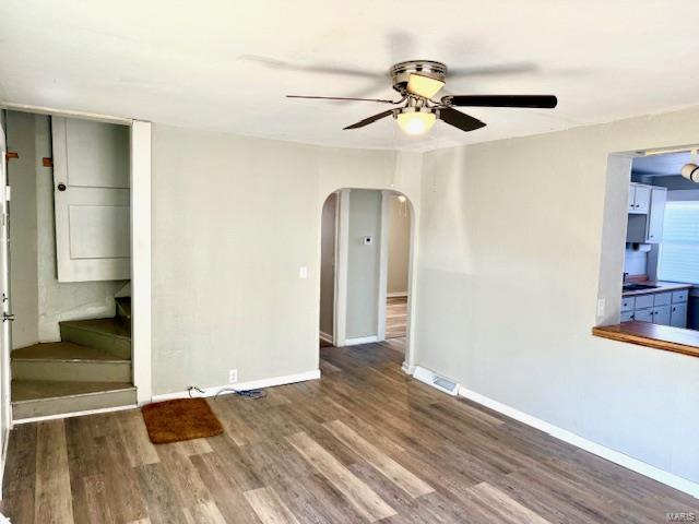 empty room featuring hardwood / wood-style flooring and ceiling fan