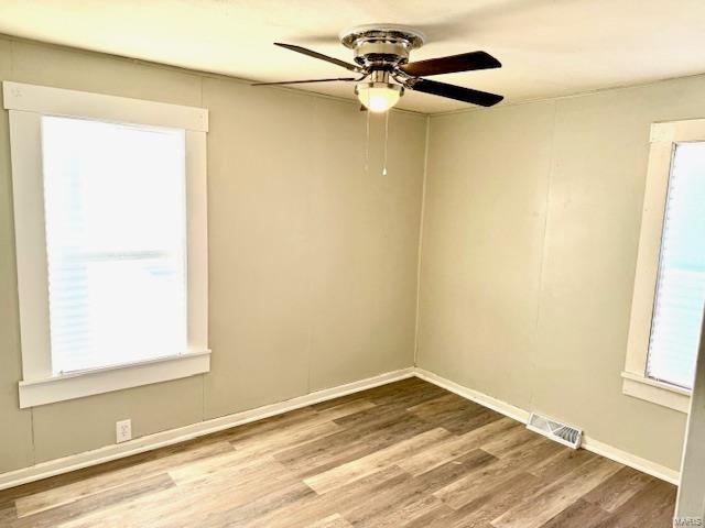 unfurnished room featuring wood-type flooring and ceiling fan