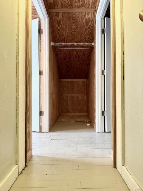 hallway with wood walls