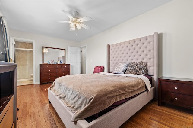 bedroom featuring a ceiling fan, connected bathroom, and hardwood / wood-style floors