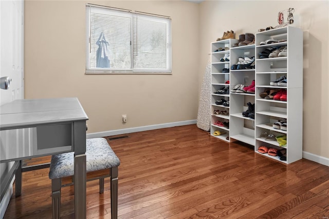 office space featuring visible vents, baseboards, and wood finished floors