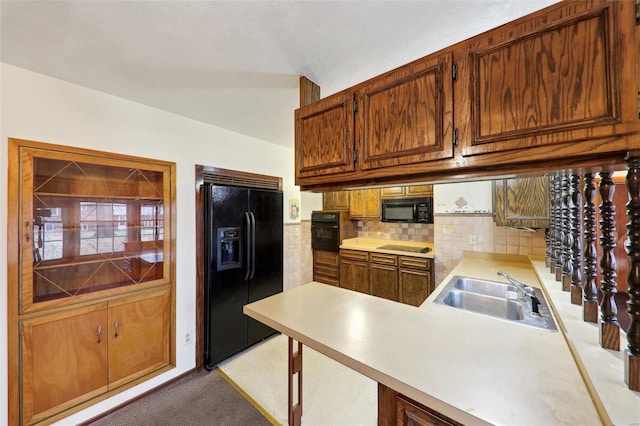 kitchen with tasteful backsplash, sink, light carpet, and black appliances