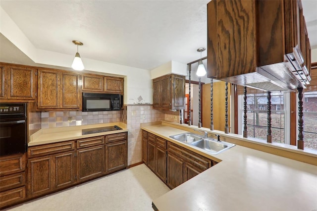 kitchen with decorative light fixtures, sink, decorative backsplash, and black appliances