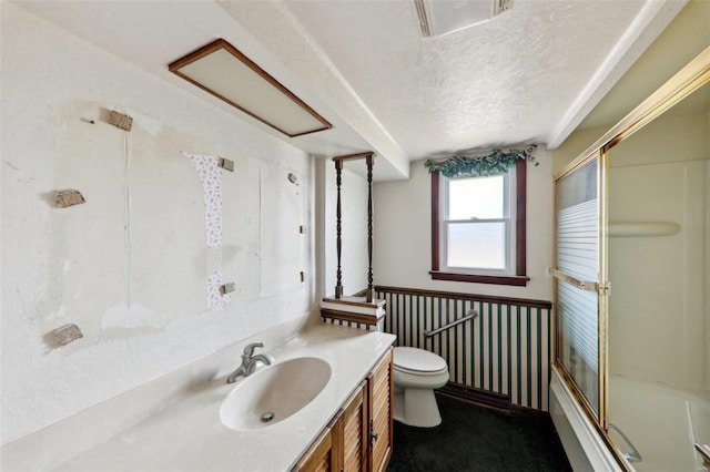 full bathroom featuring vanity, bath / shower combo with glass door, a textured ceiling, and toilet