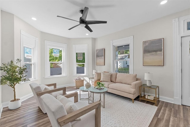 living room featuring hardwood / wood-style flooring, plenty of natural light, and ceiling fan