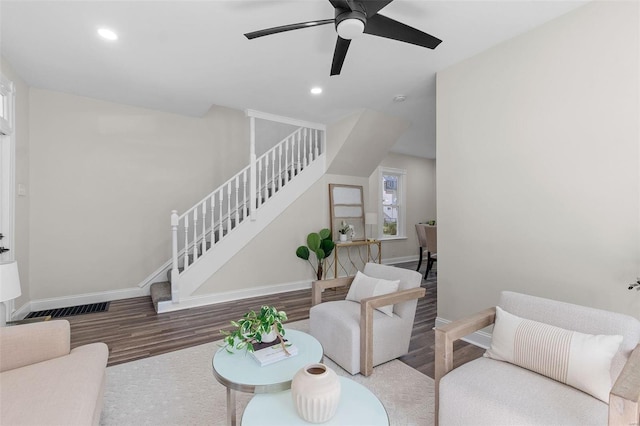 living room with hardwood / wood-style floors and ceiling fan