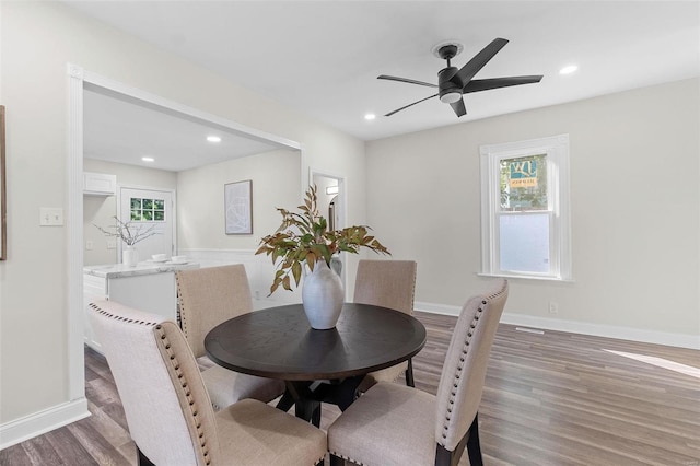 dining area with hardwood / wood-style flooring and ceiling fan