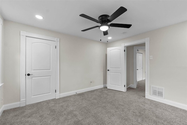 unfurnished bedroom featuring light carpet and ceiling fan