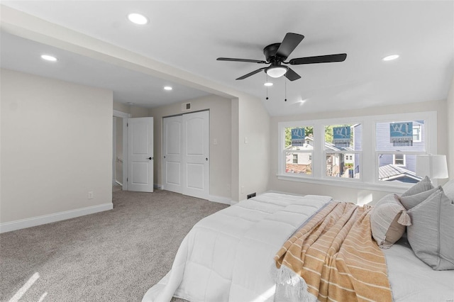 carpeted bedroom featuring lofted ceiling, ceiling fan, and a closet