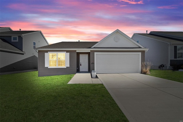 ranch-style house with a garage and a yard