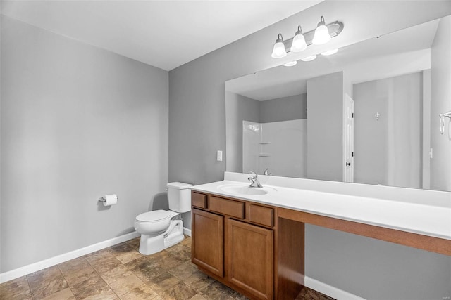 bathroom featuring vanity, toilet, and a shower