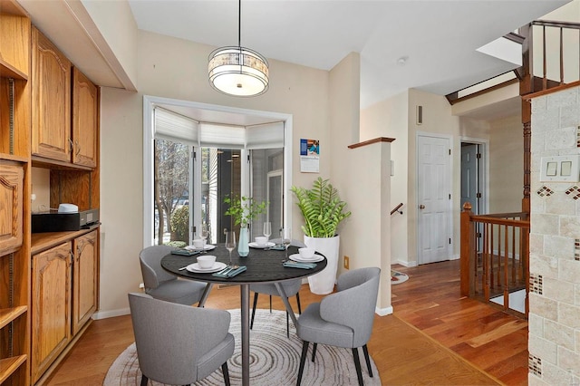 dining space with light hardwood / wood-style floors