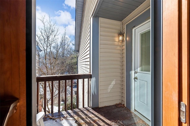 view of snow covered back of property