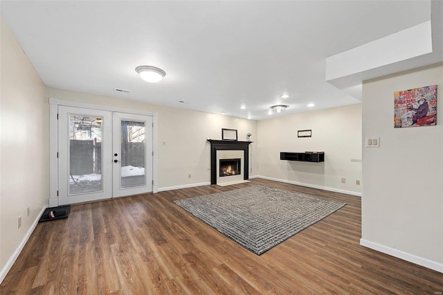 unfurnished living room featuring french doors and dark hardwood / wood-style floors