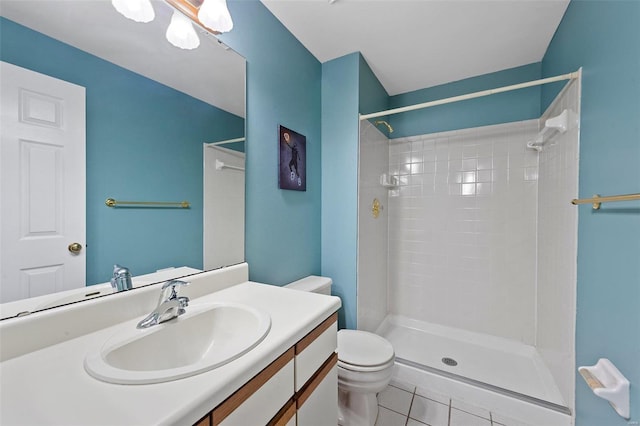 bathroom with tile patterned flooring, vanity, toilet, and walk in shower