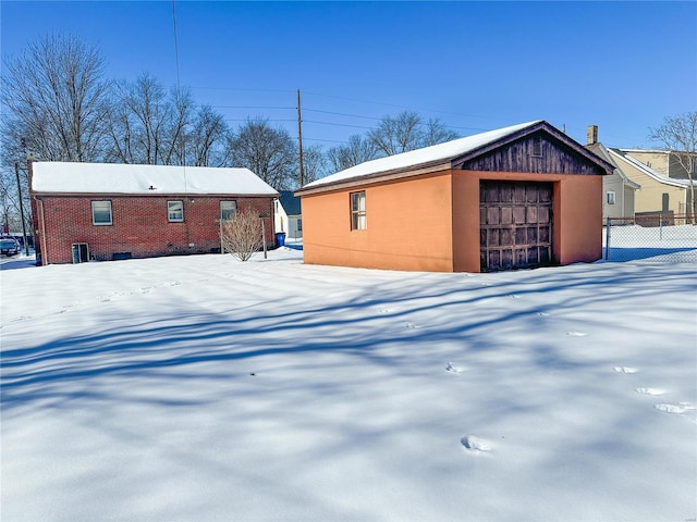 exterior space featuring an outbuilding, a garage, and central AC unit