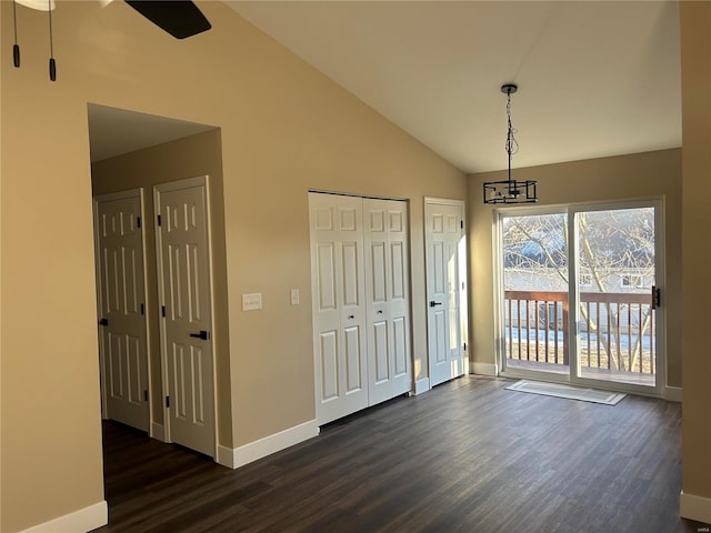 entrance foyer with dark wood-type flooring and high vaulted ceiling