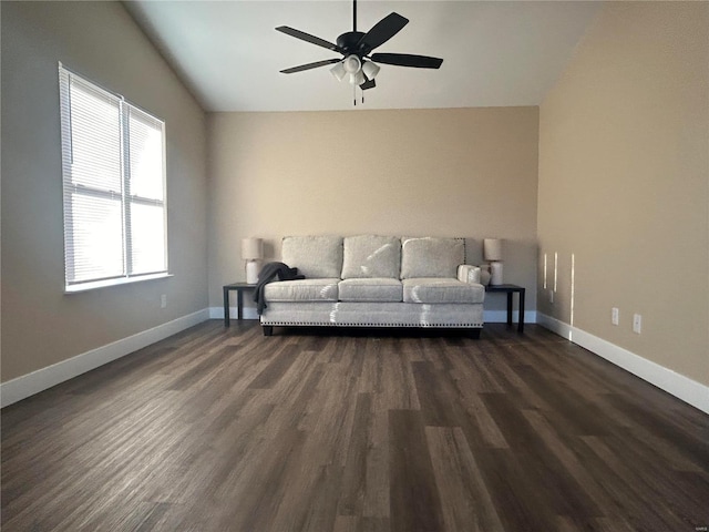 unfurnished living room featuring vaulted ceiling, dark hardwood / wood-style floors, and ceiling fan