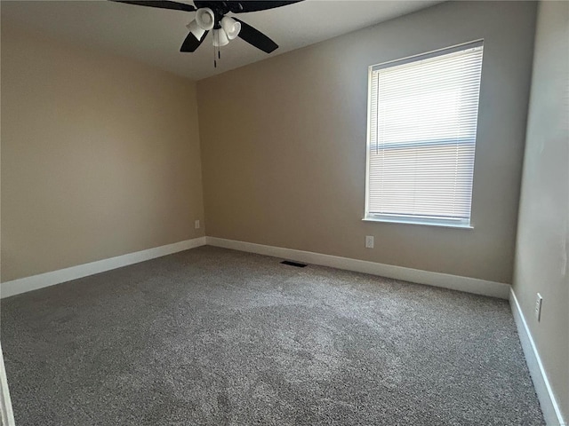 unfurnished room with ceiling fan, carpet floors, and a wealth of natural light