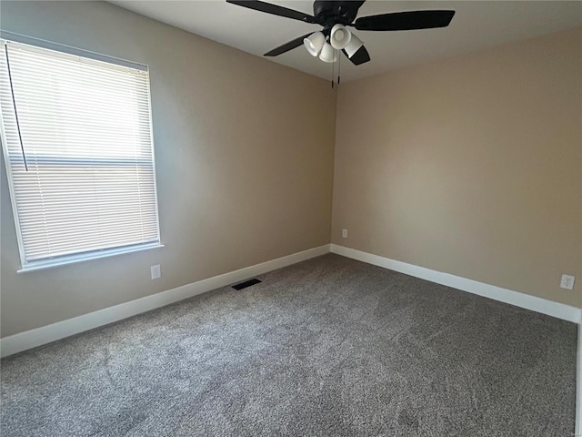 carpeted spare room featuring ceiling fan