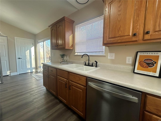 kitchen with vaulted ceiling, dark hardwood / wood-style flooring, dishwasher, and sink