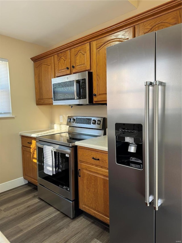 kitchen featuring dark hardwood / wood-style floors and appliances with stainless steel finishes