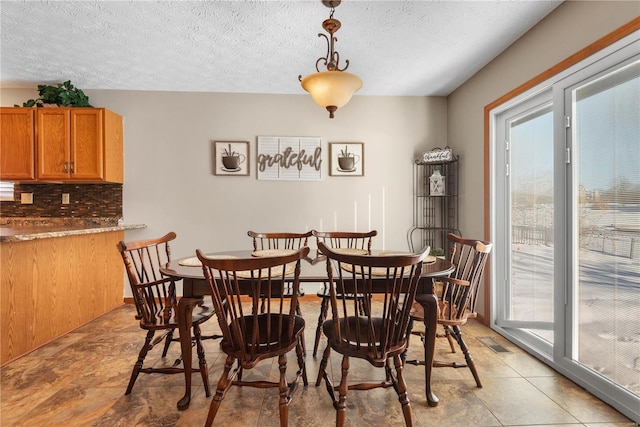 dining space featuring a textured ceiling