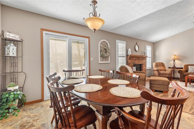 dining area featuring a fireplace and a textured ceiling