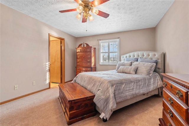 carpeted bedroom with a textured ceiling and ceiling fan