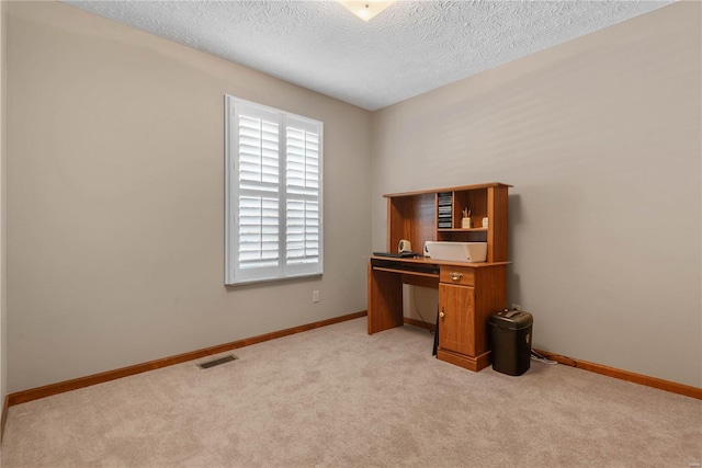 office area with light colored carpet and a textured ceiling